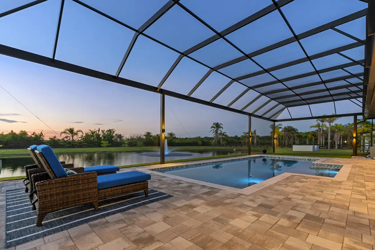 Wide view of the screened pool and lanai at dusk